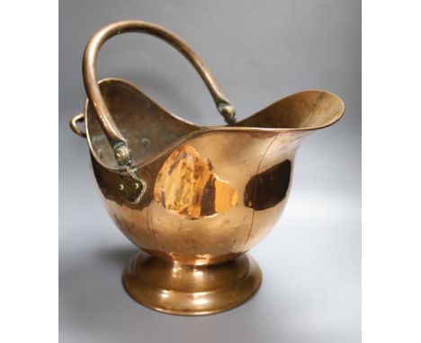 A 19th century planished copper helmet coal scuttle