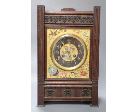 A French Aesthetic style oak mantel clock with enamelled ceramic dial, gong striking movement, 22cm wide