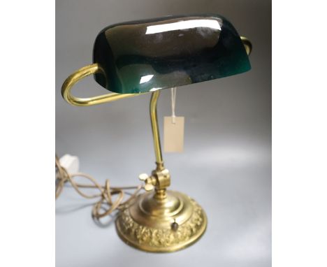 A brass desk lamp with green glass shade