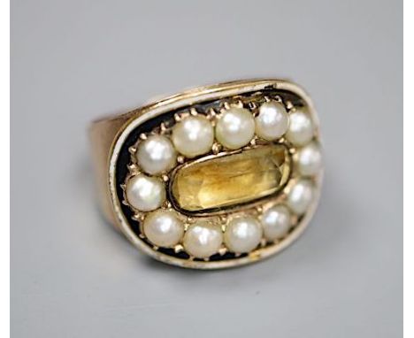 A George III yellow metal, black enamel, split pearl and foil backed citrine set oval mourning ring, the interior inscribed '