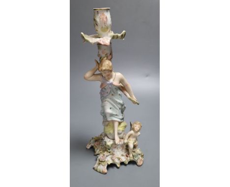 A German porcelain candlestick with lady and cherub, height 26.5cm (a.f.)CONDITION: Figural candlestick - sconce has been glu