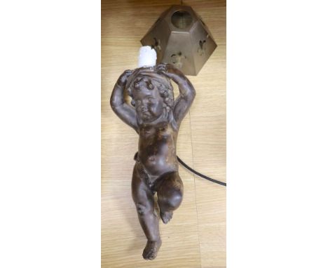 A plaster cherub candlestick, converted to a lamp