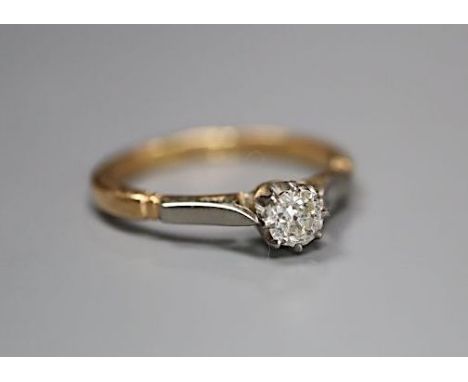 An 18ct and plat, solitaire diamond ring, size M, gross 2.6 grams, the stone weighing approximately 0.18-0.20ct.