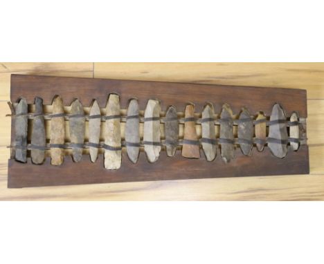 A xylophone formed from Stone Age flints, length 60cm