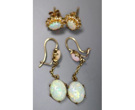 A pair of yellow metal and two stone oval white opal drop earrings, 32mm, gross 2.5 grams, and a pair of 750 and opal ear stu