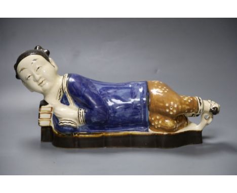 A Chinese porcelain pottery figural pillow, 42cm wide with related Hong Kong certificateCONDITION: Her right ear shallow chip