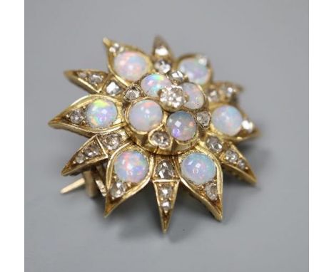 An Edwardian yellow metal, opal and diamond set flower head brooch, 25mm, gross 6.9 grams.