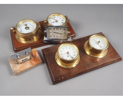 An Art Deco style chrome desk clock, a barometer and separate clock mounted on a wooden plaque, another similar, and a desk c