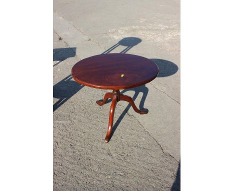 A mahogany oval top occasional table, on turned column and tripod splay supports, 22" wide x 27" deep x 18" high, and a simil