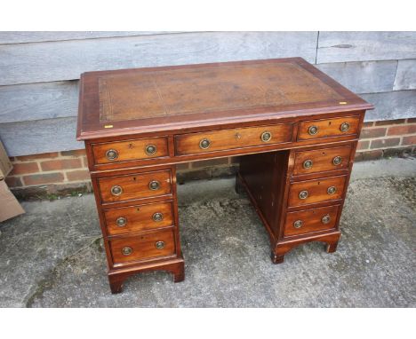 A mahogany double pedestal desk, fitted tooled brown leather top and nine drawers, on bracket feet, 40" wide x 24" deep x 28 