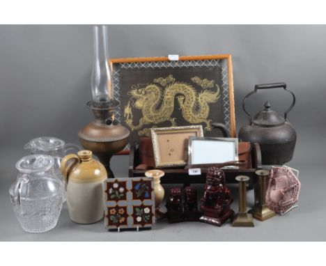 A copper oil lamp, a pair of brass candlesticks, a pair of Chinese resin Dogs of Fo, a metal kettle, and other items 
