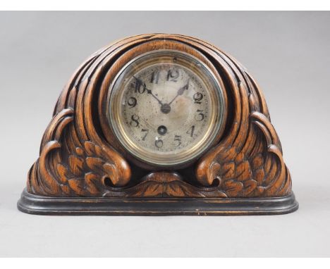 An early 20th century carved oak mantel clock with silvered dial, 7 1/4" high 