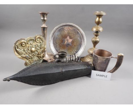 A pair of embossed brass pillar candlesticks, two wall sconces, a bowfront sconce and other metalwares, various 
