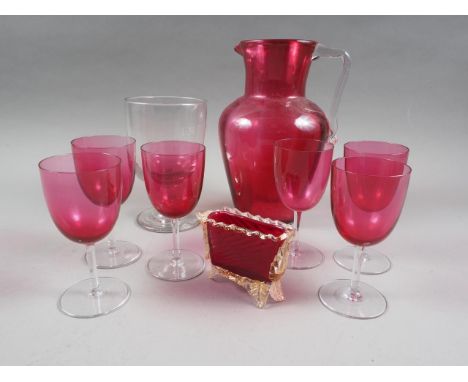 A ruby glass jug, six ruby glass wines and a rummer 