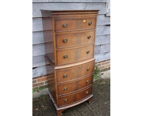 A mahogany bowfront chest on chest of six drawers with ring handles, 21" wide x 17" deep x 51" high 