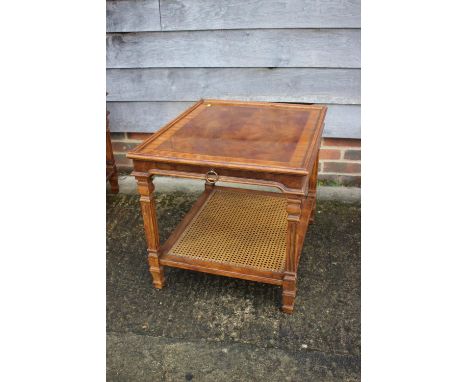 A walnut and banded lamp table, fitted slide and cane top undertier, on square taper supports, 26" square x 22" high 