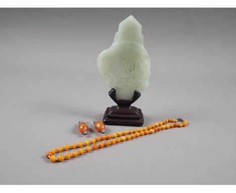 A Chinese jade roundel with carved dragon decoration, on stand, 6" high overall, a beaded necklace and a similar pair of earr