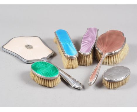 A silver and blue enamel backed brush, three other similar enamelled brushes, a chrome plated brush and another silver backed