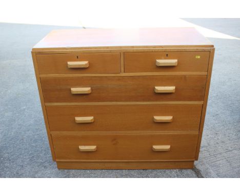 A 1950 light oak chest of two short and three long graduated drawers, on block base, 42" wide x 19" deep x 37 1/2" high 