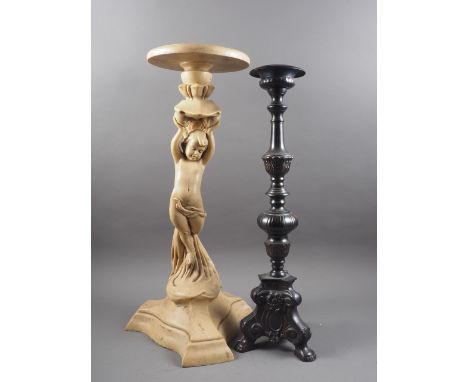 A composition torchere stand with putti support, on trefoil base, 25 1/2" high, and a patinated brass pricket candlestick, 24
