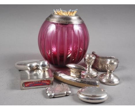 A silver hip flask, a white metal rimmed cranberry glass table vesta, 5" high, two silver vestas, a pair of silver squat cand