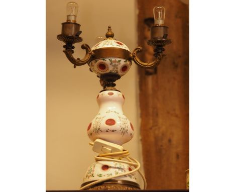 A Bohemia red and white overlaid glass and brass mounted three-light table lamps 