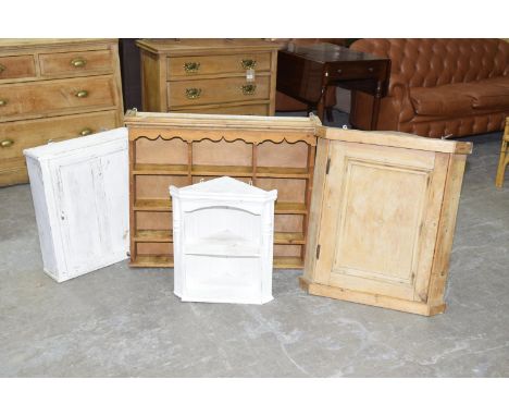 Four assorted pine hanging cupboardsTo include a painted pine cabinet with a single door, a small painted pine hanging corner