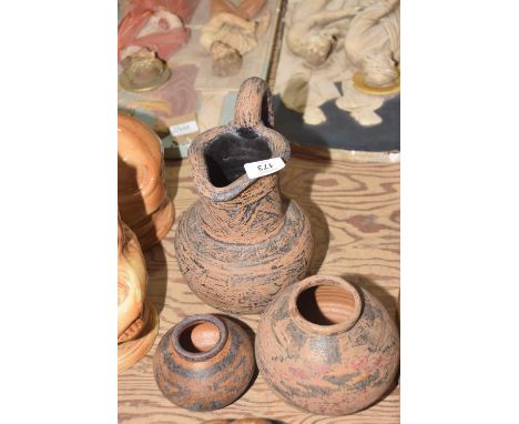 A group of three Pre-Colombian style pottery vesselsComprising of a squat form vase with remnants of painted geometric design