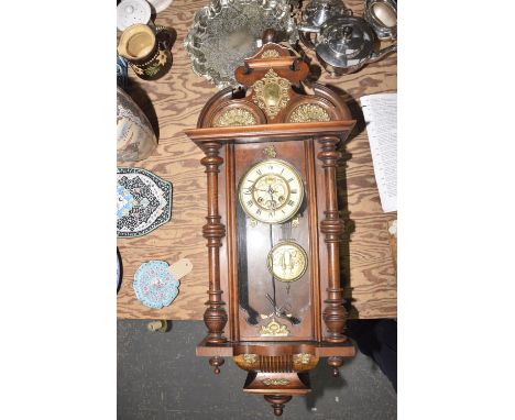 A Victorian walnut Vienna style wall clockThe architectural case applied with gilt metal appliques having turned columns flan