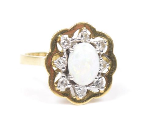 An 18ct gold opal and diamond cluster ringThe oval opal cabochon within a single cut diamond openwork surround, ring size N, 