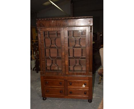 A Georgian mahogany glazed bookcaseHaving a bobbin turned frieze above a pair of astragal glazed drawers enclosing three shel