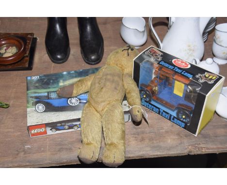 A group of three vintage toys To include a plush teddy bear, a Coronet veteran taxi lamp and a Lego Renault model D391. (3) 