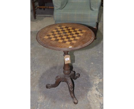 A Victorian walnut chest top tripod tableThe circular top with a inlaid checkered chess board raised upon a ring turned balus