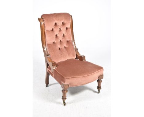 A Victorian walnut and upholstered ladies nursing chairThe button padded back flanked by curved uprights above a serpentine s