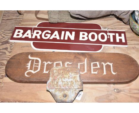 A group of three signsTo include an oval wooden 'Dresden' sign (length 59cm), a cast iron 'Pierce self trip' sign and a 'Barg