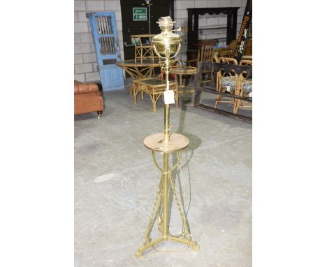 An early 20th Century brass lamp standardHaving a converted brass reservoir raised upon a telescopic brass shaft with a circu