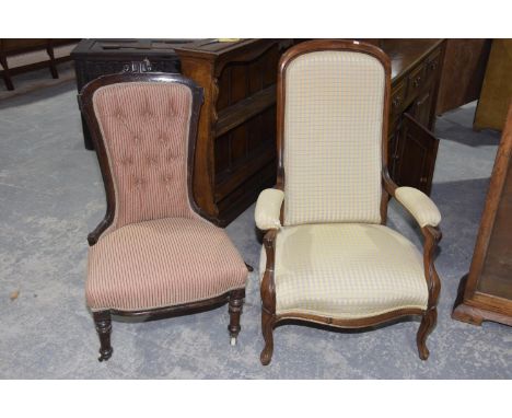 A Victorian walnut low seat open armchairHaving an arched padded back within a walnut frame above outswept padded arms and sp