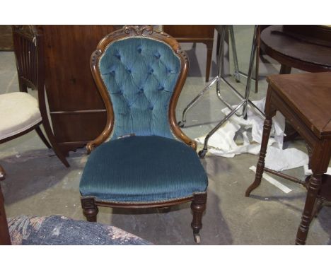 A Victorian walnut and upholstered nursing chairHaving a balloon button back within a carved walnut frame above a bow front s