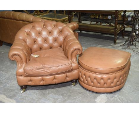 A tan leatherette tub chairHaving an arched button back above padded scroll arms enclosing a single loose cushion, raised upo