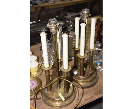 A pair of brass candelabra table lightsThe table lights of circular plinth base rising to three shaft bodies with circular te