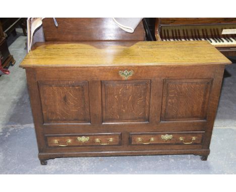 An 18th Century honey oak mule chestHaving a rectangular hinged top above three invert moulded panels and two lower crossband