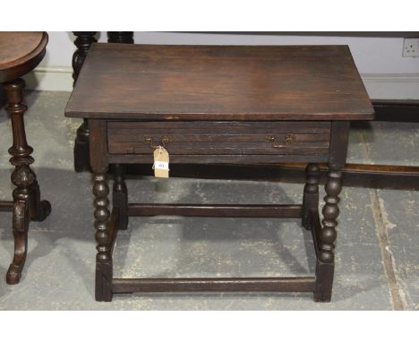 An 18th Century and later oak side tableHaving a rectangular top above a single frieze drawer raised upon bobbin turned legs 