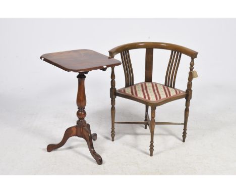 An Edwardian mahogany corner chairHaving a curved top rail raised on turned spindles above a shaped padded seat upon conformi