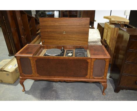 A 1970's Dynatron stereogram The burr walnut veneered cabinet enclosing a Garrard turn table flanked by fitted speaker within