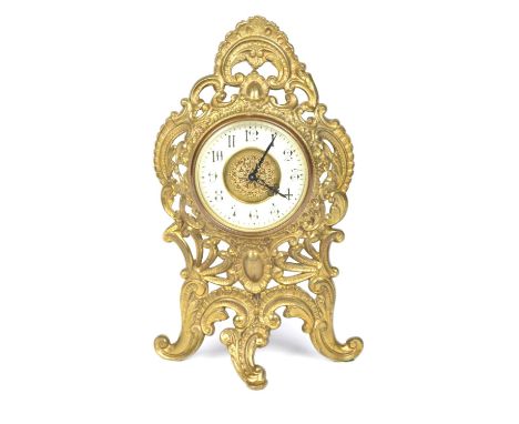 An early 20th Century French brass cased easel mantle clock The 9cm enameled bezel painted with Arabic numerals within an orn
