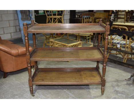 A late Victorian oak three tier dumb waiterHaving  ring turned button finials above ring turned and tapering shafts supportin