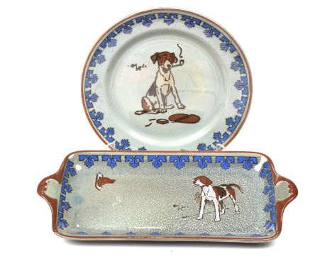 Two Royal Doulton Titanium ware Cecil Aldin platesThe first dinner plate depicting a dog smoking a pipe within foliate blue b