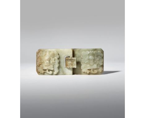 A CHINESE CELADON JADE BELT BUCKLE 18TH/19TH CENTURY Each of the two sections carved in relief with a flowerhead, the hook wo