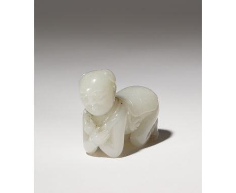 A CHINESE WHITE JADE CARVING OF A BOY QING DYNASTY OR LATER The child depicted bent over resting on his knees and elbows, wit