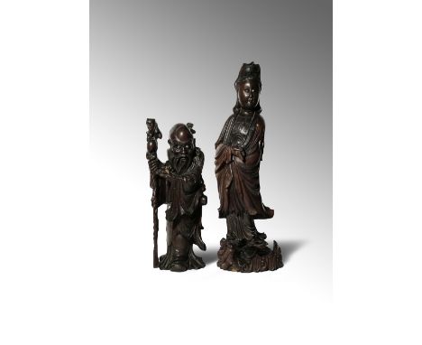 TWO LARGE CHINESE WOOD FIGURES 19TH/20TH CENTURY The larger figure carved as Guanyin standing upon a dragon-carp holding a sh